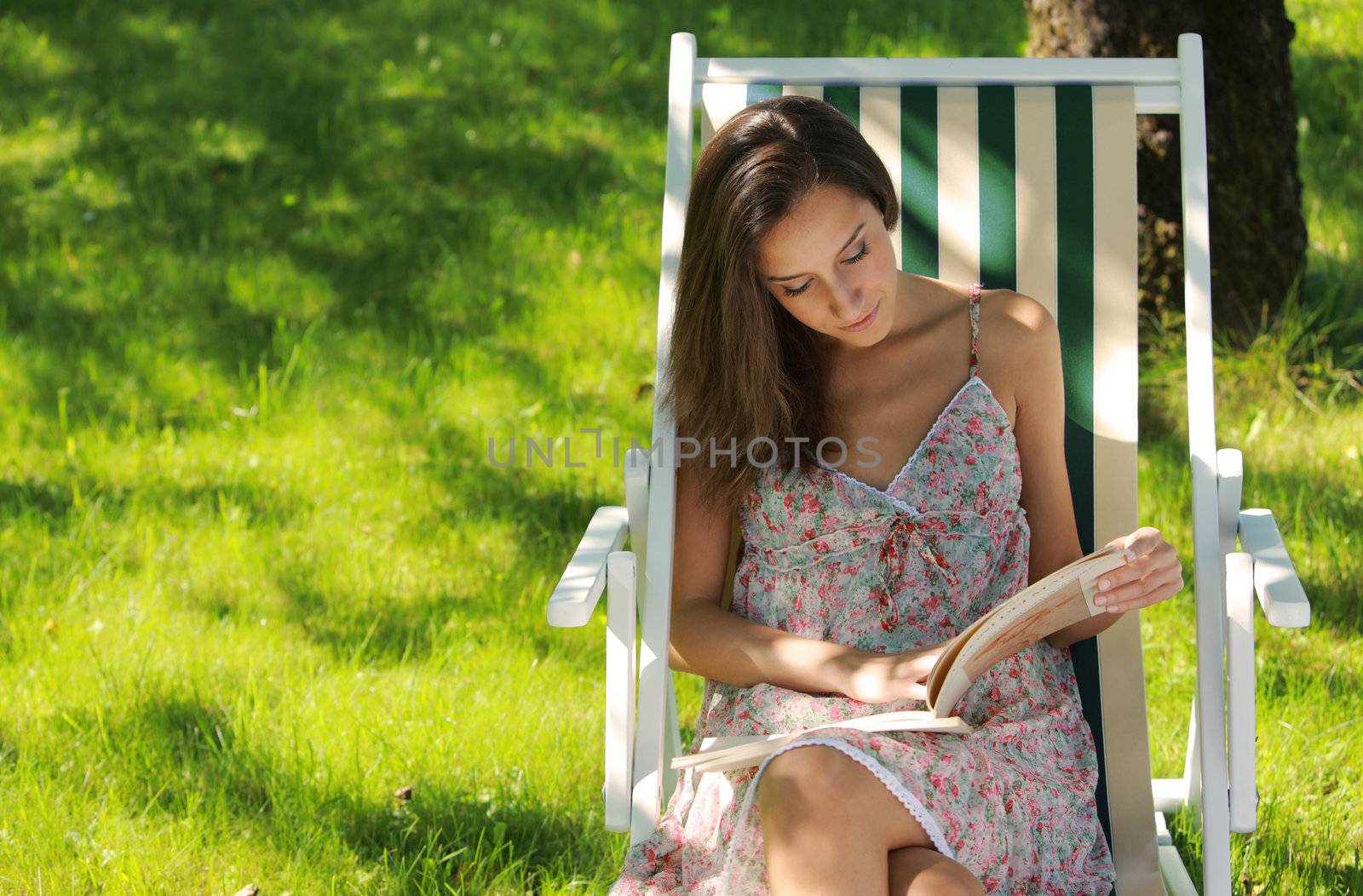 Young woman reading a book at park