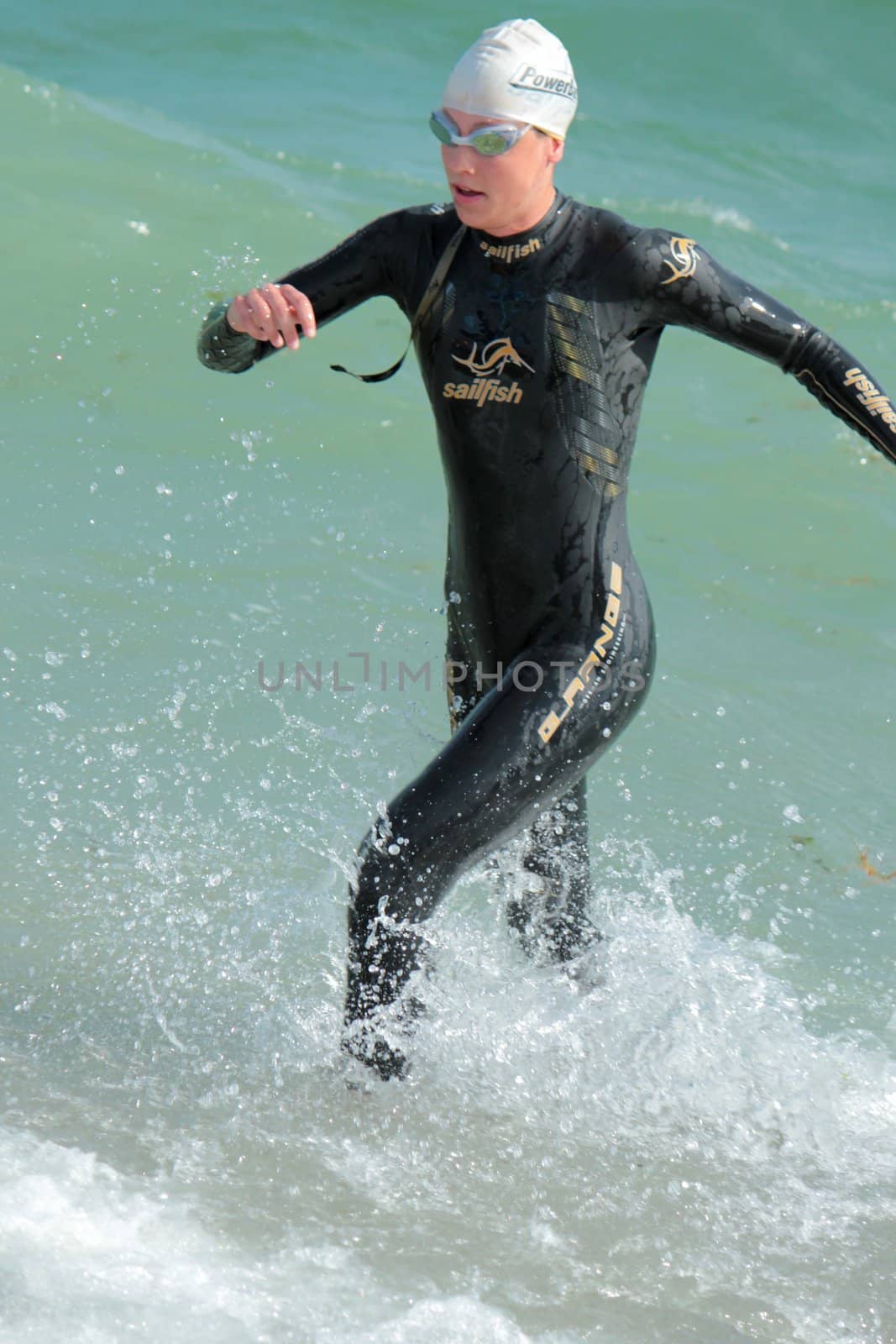 One unidentified female athlet going out of water at the 2012 International Geneva Triathlon, Switzerland.