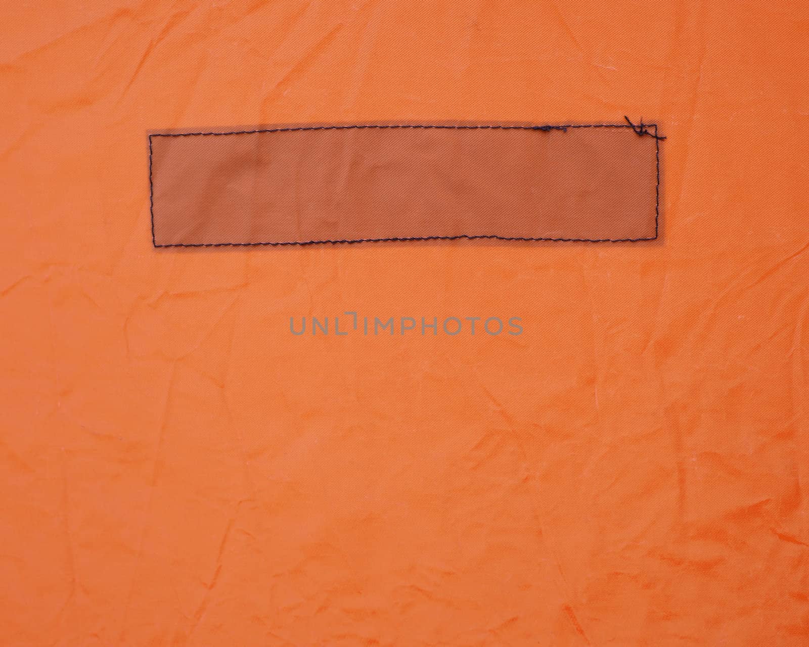 Rectangle stitched on a heavy orange vinyl fabric
