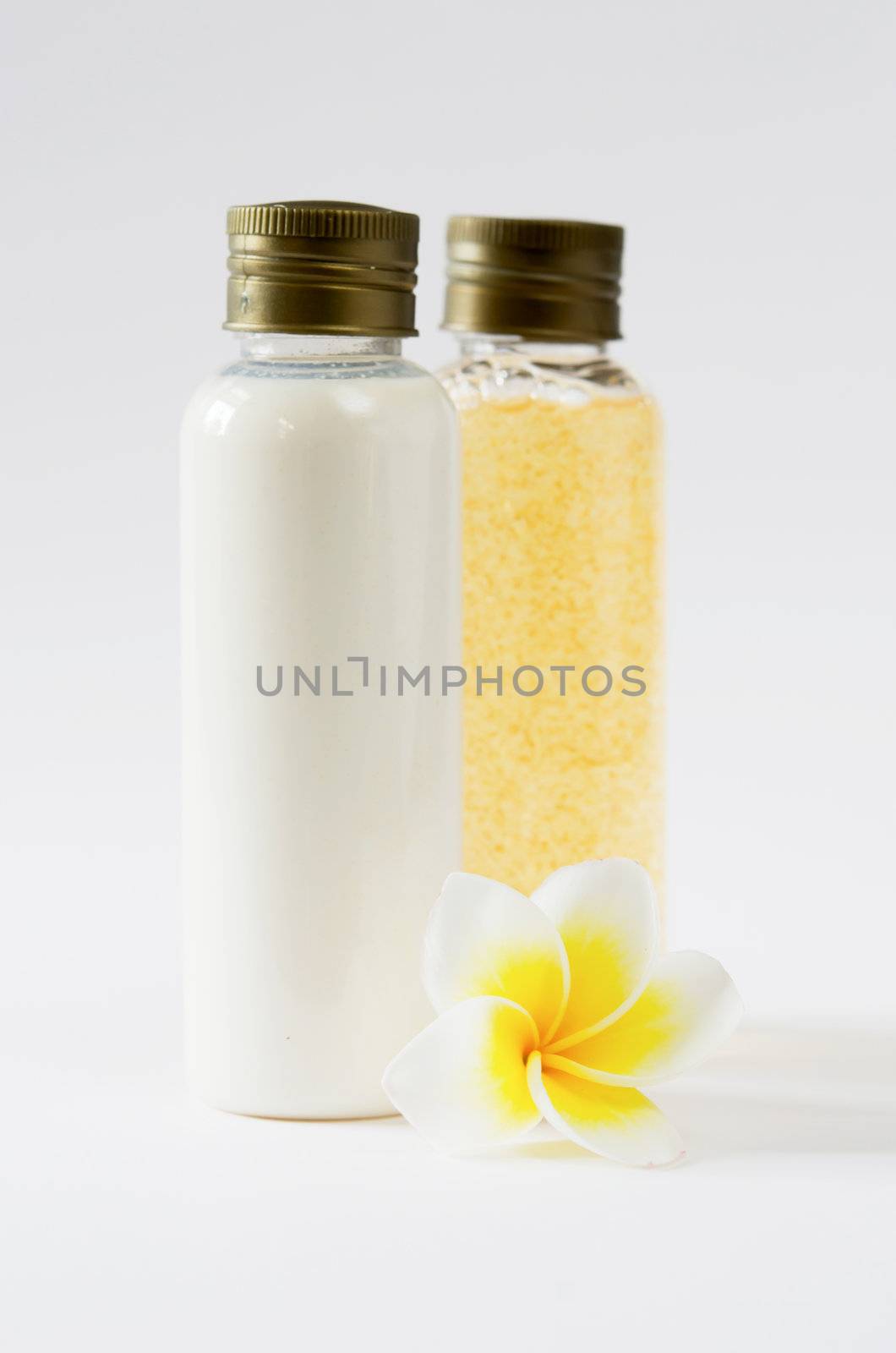  two bottle and  fresh frangipani  on white background