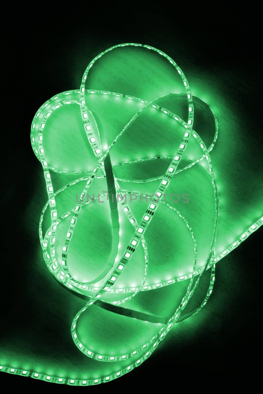 green led strip with a glue layer, background in the dark, illuminated by strip
