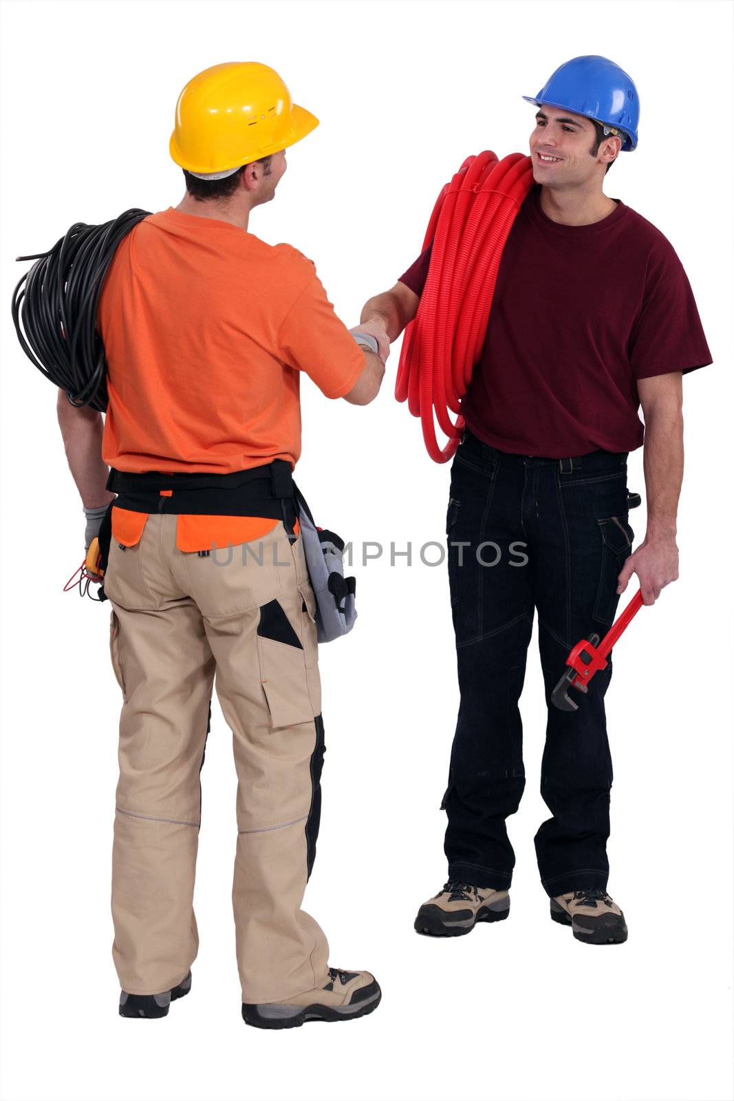 Tradesmen shaking hands in agreement by phovoir