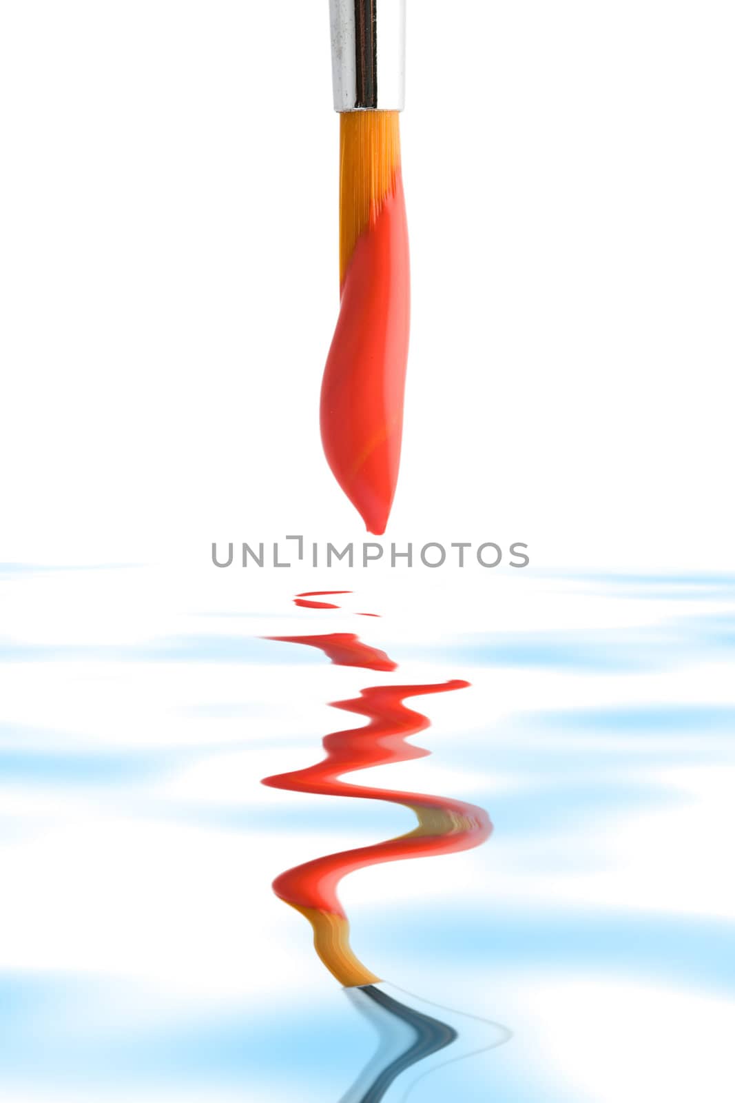 Stock photo: an image of a brush with red paint on it