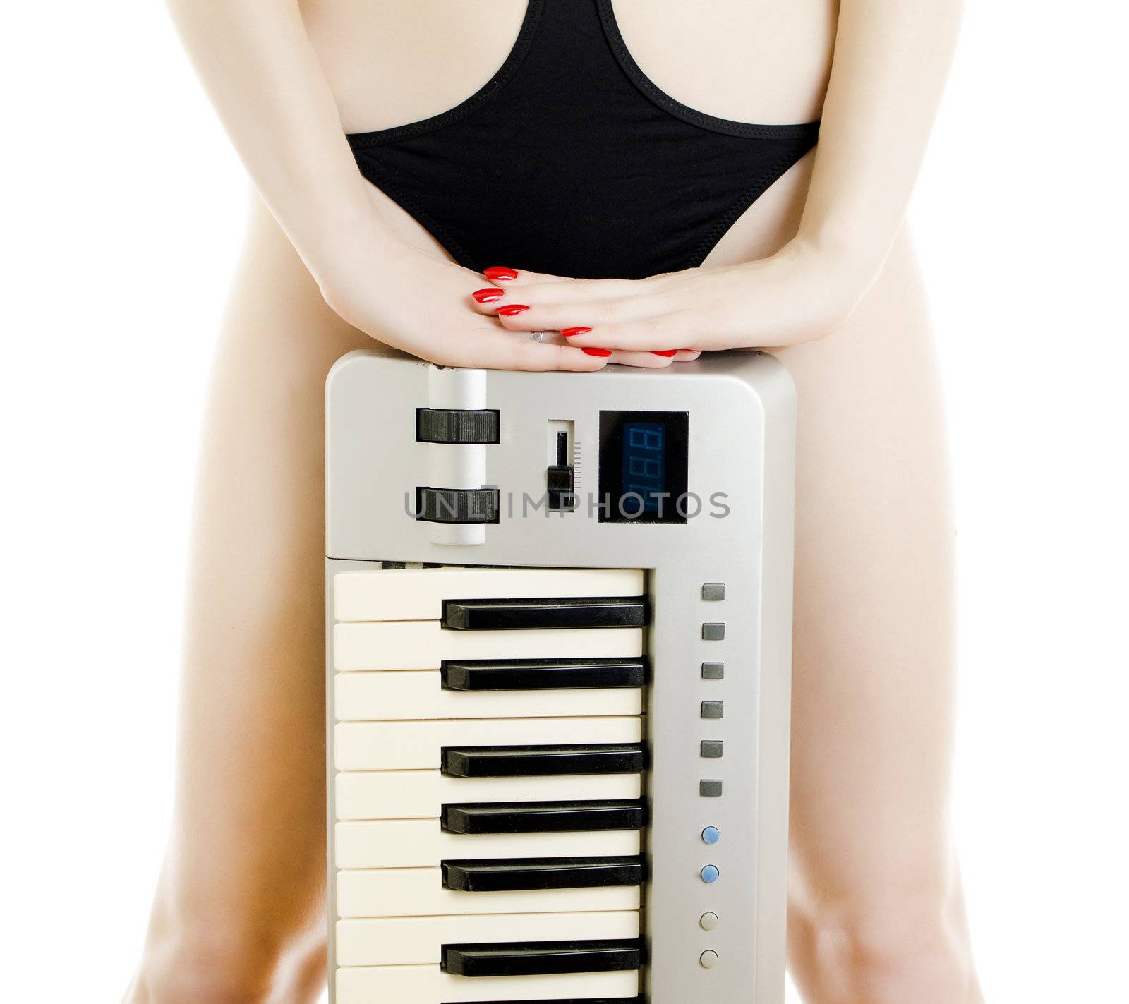 Part of Woman body in black swimsuit with Piano keyboard. Isolated on white.