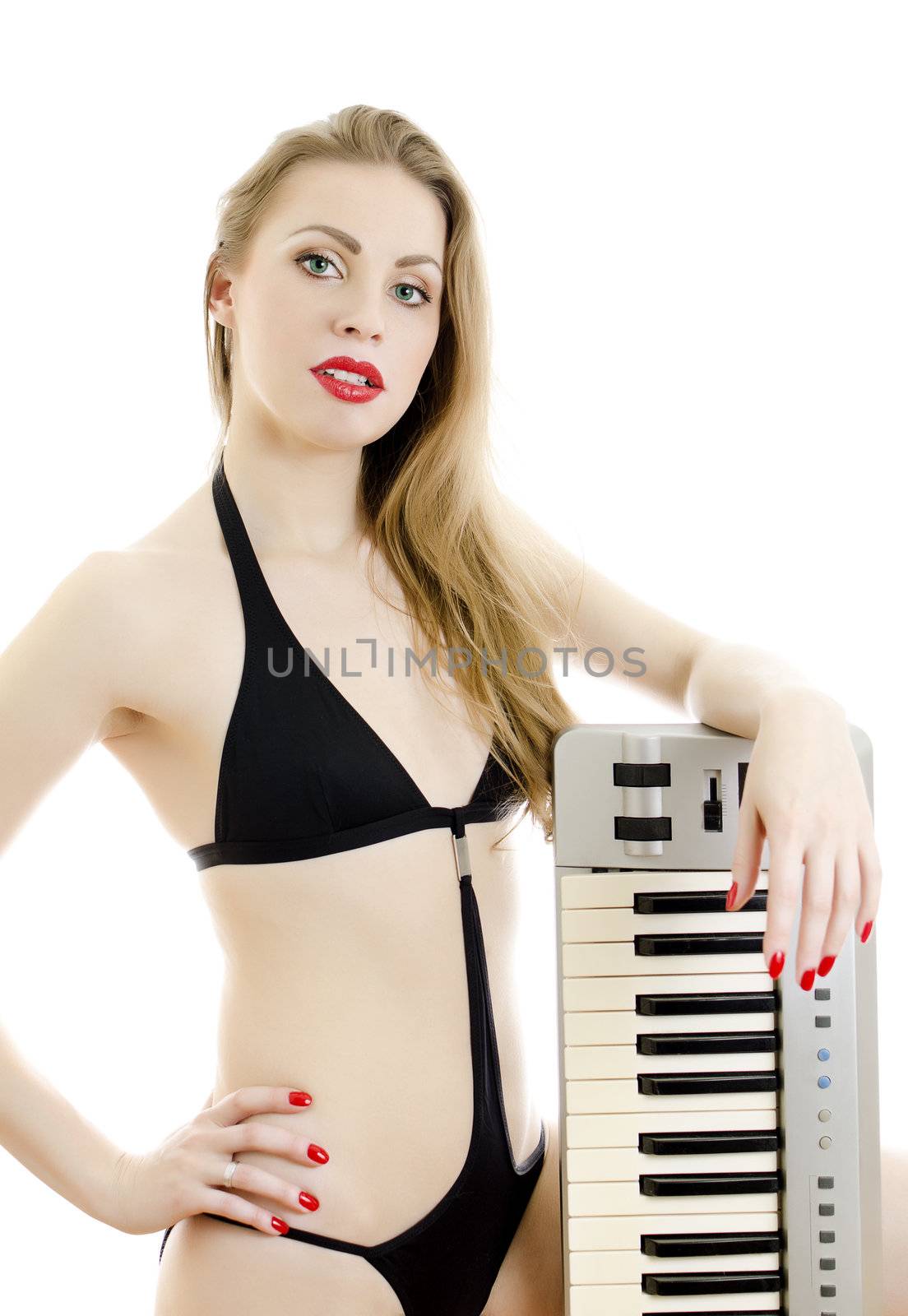 Woman in black swimsuit posing with Piano keyboard. Isolated on white.