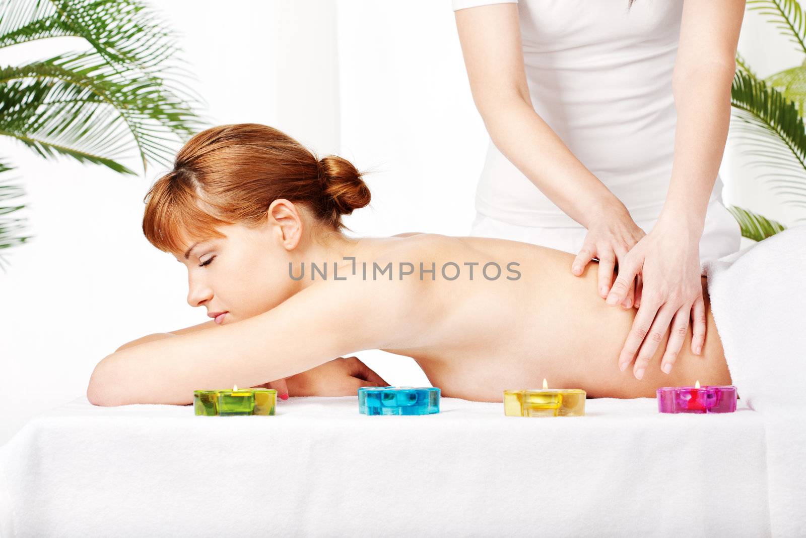 Pretty woman getting a back massage in spa salon