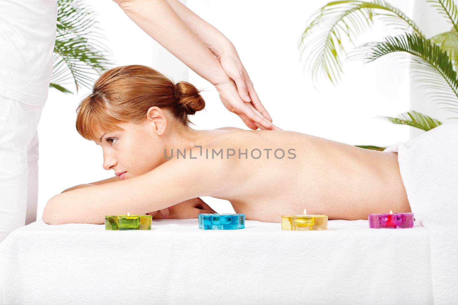 Pretty woman getting a back massage in spa salon