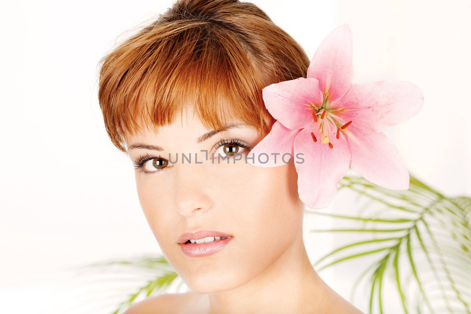 Portrait of a pretty woman with flower in hair