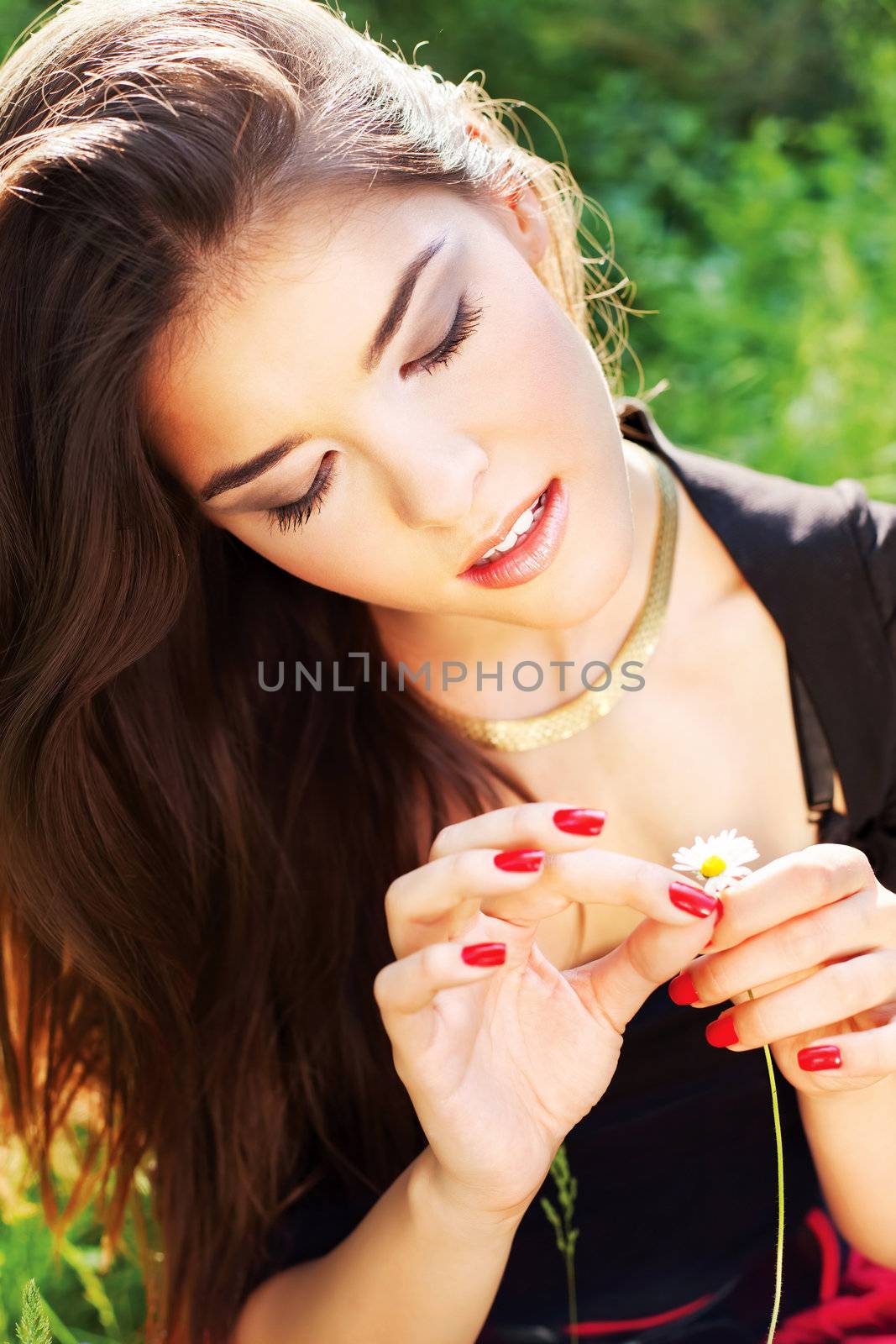 Pretty woman on sunny day in park by imarin