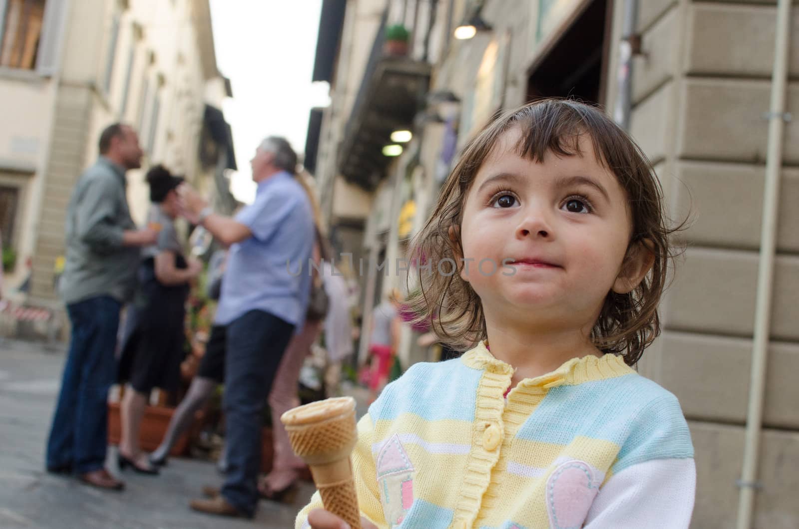 Baby girl eating Ice Cream in the City Streets, Italy