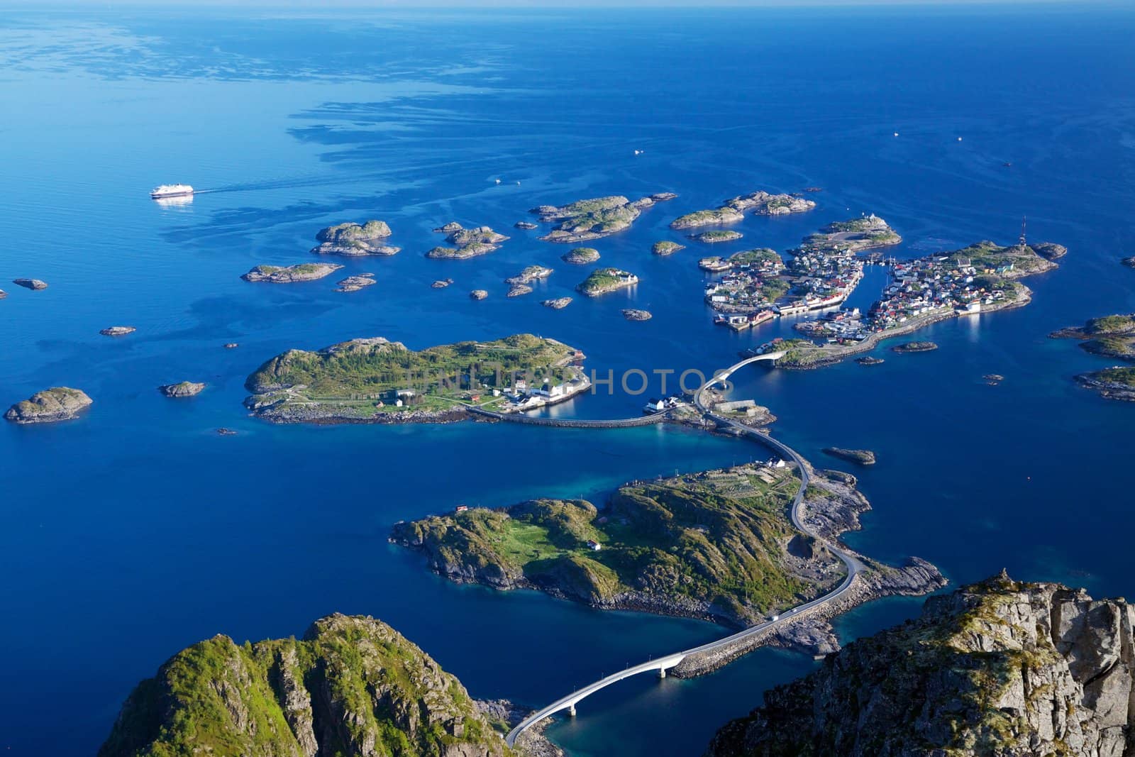 Scenic town of Henningsvaer on Lofoten islands in Norway with large fishing harbour and bridges connecting rocky islands