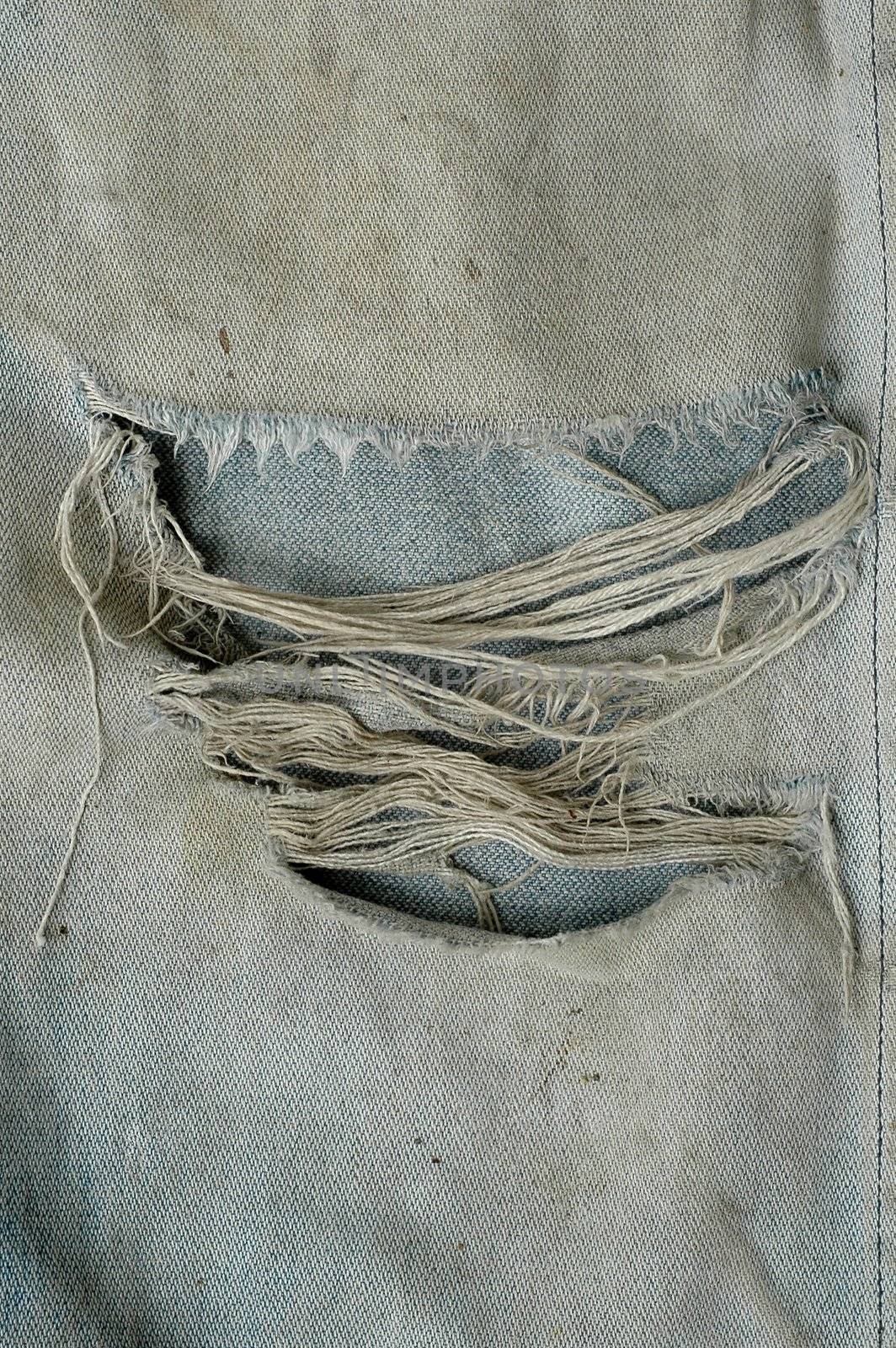 dirty old jeans torn close-up