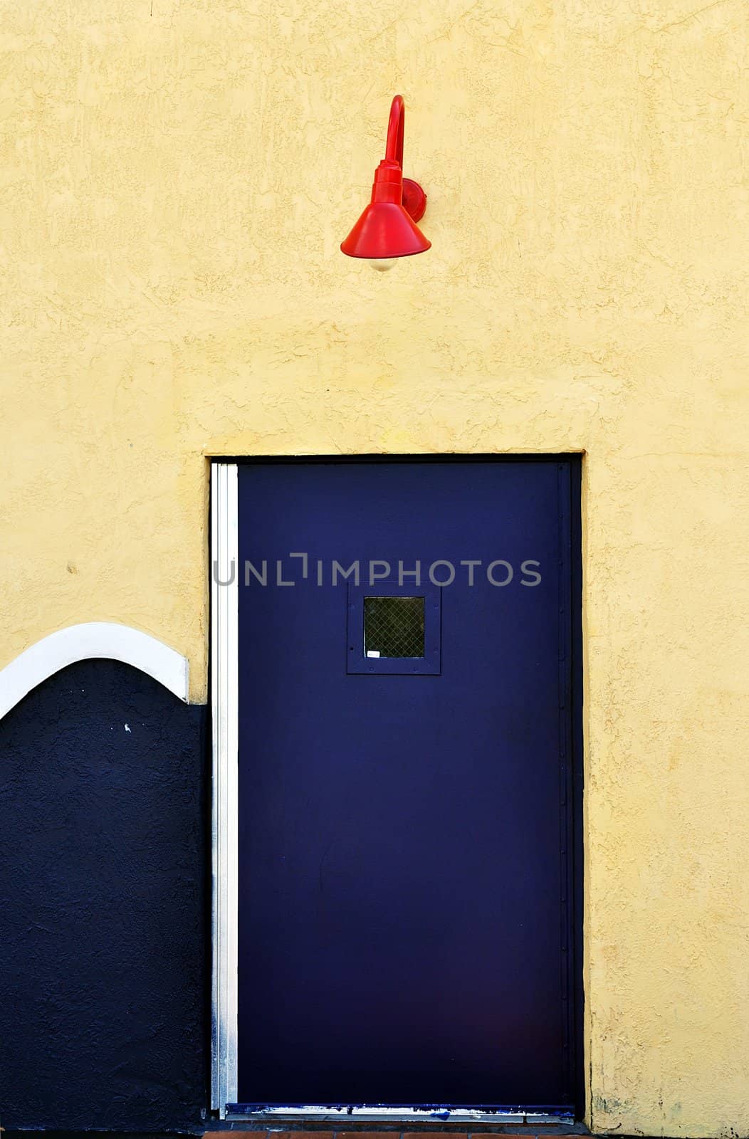 Blue commercial backdoor with red lamp above it.