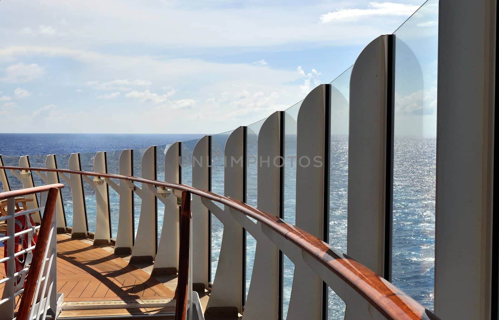 View of a cruise ship deck sweeping around a ship's ladder near the stern.