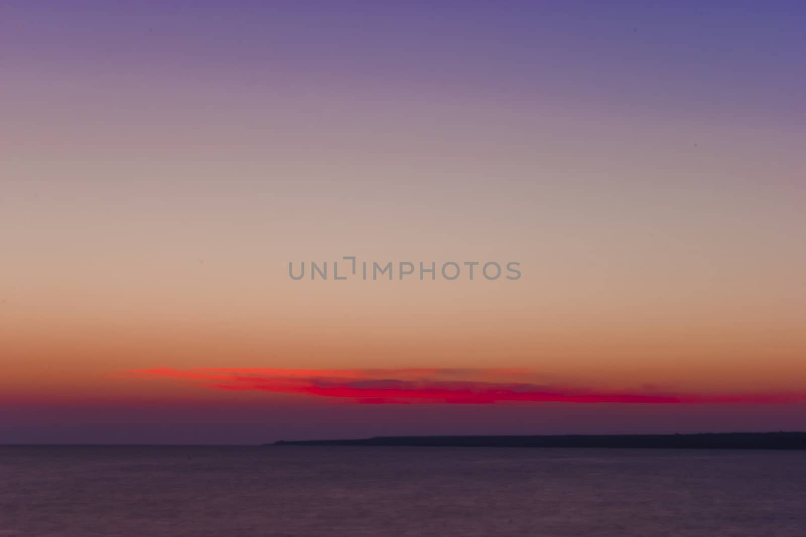 purple sunset and calm water of the sea