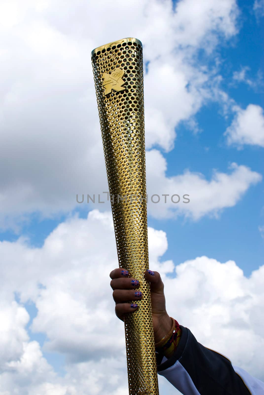 LONDON, UNITED KINGDOM-JULY 21: Olympic games volunteer holding the torch at Greenwich on July 21, 2012 in London, UK. The event is from July 27 to August 12, 2012.