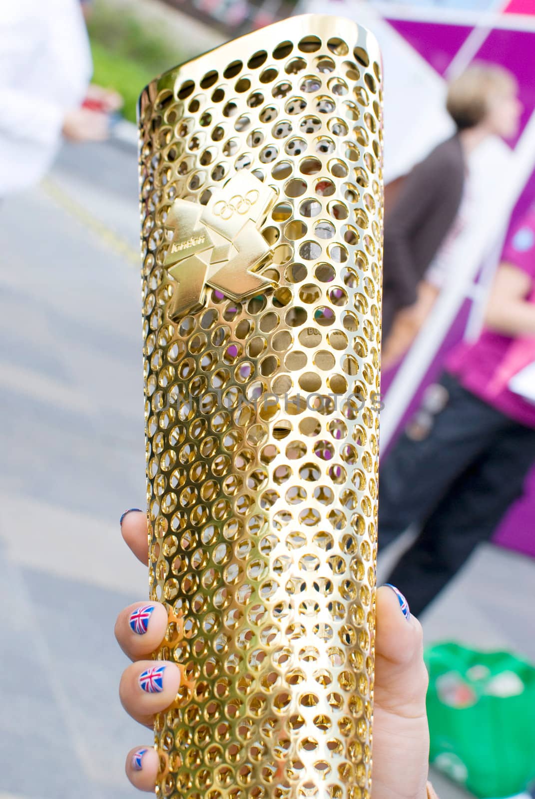 LONDON, UNITED KINGDOM-JULY 21: Olympic games volunteer holding the torch at Greenwich on July 21, 2012 in London, UK. The event is from July 27 to August 12, 2012.