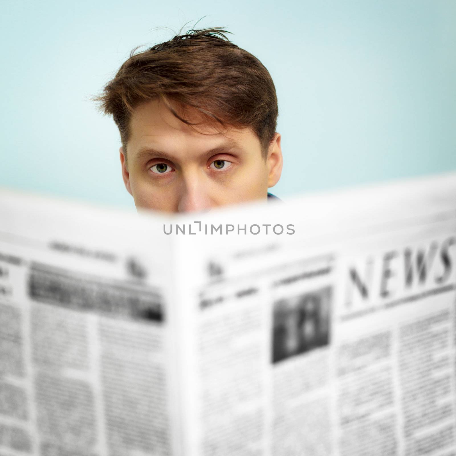Man reads news in the newspaper by pzaxe