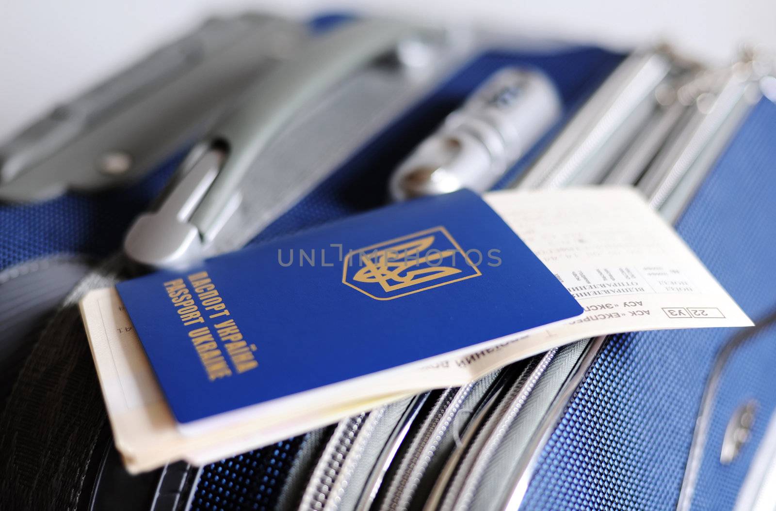 An image of a passport and tickets on a valise