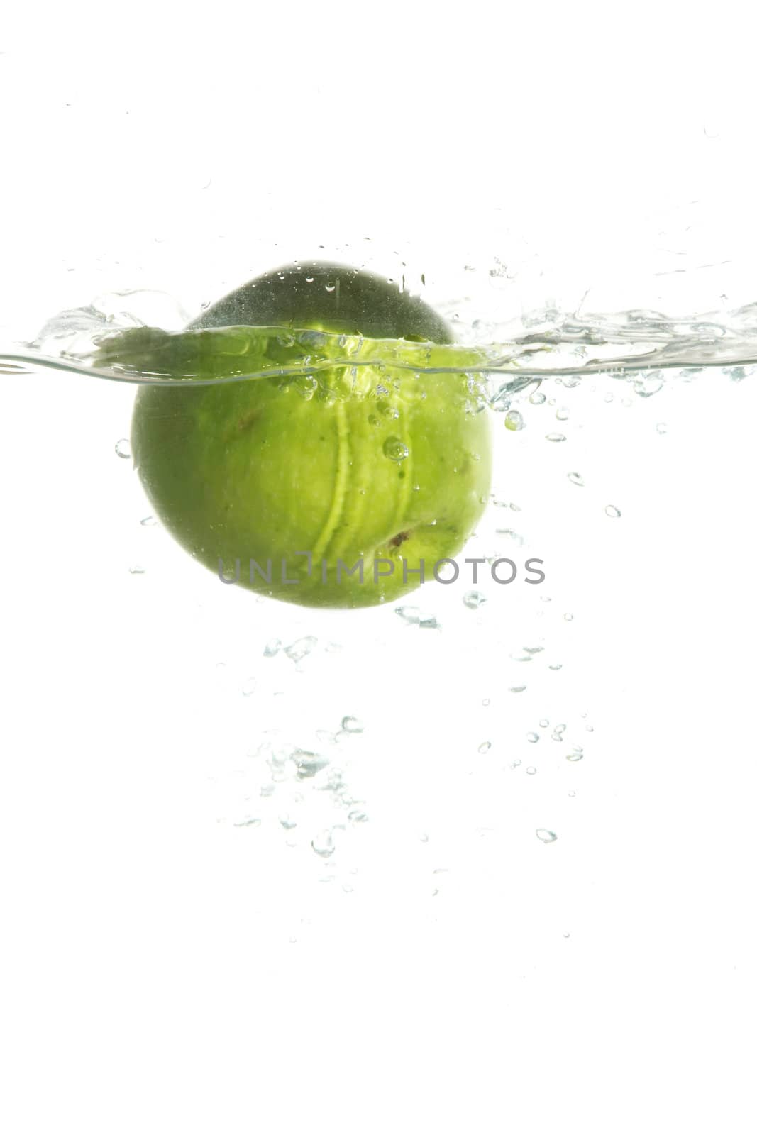 Green apple in water by velkol