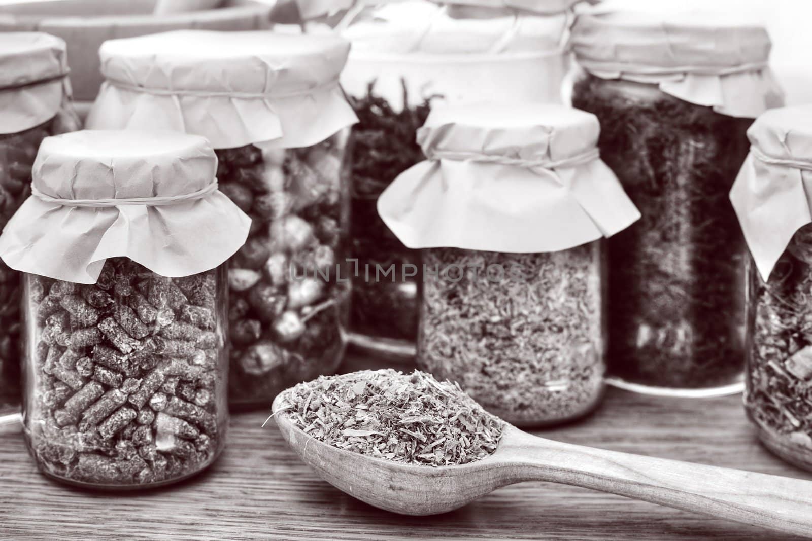 An image of herbal tea in a wooden spoon and glasses