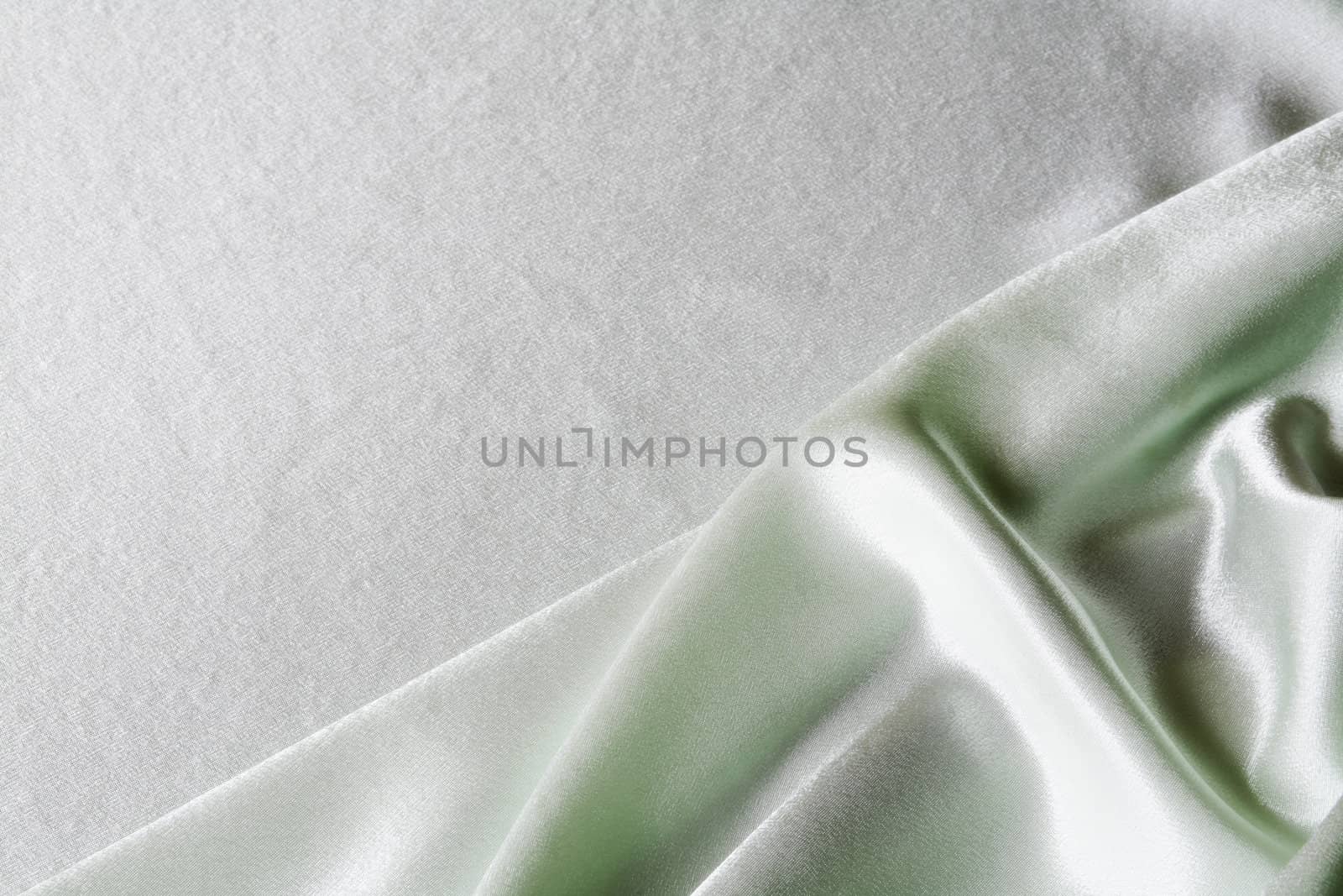 An image of folds of green glace cloth