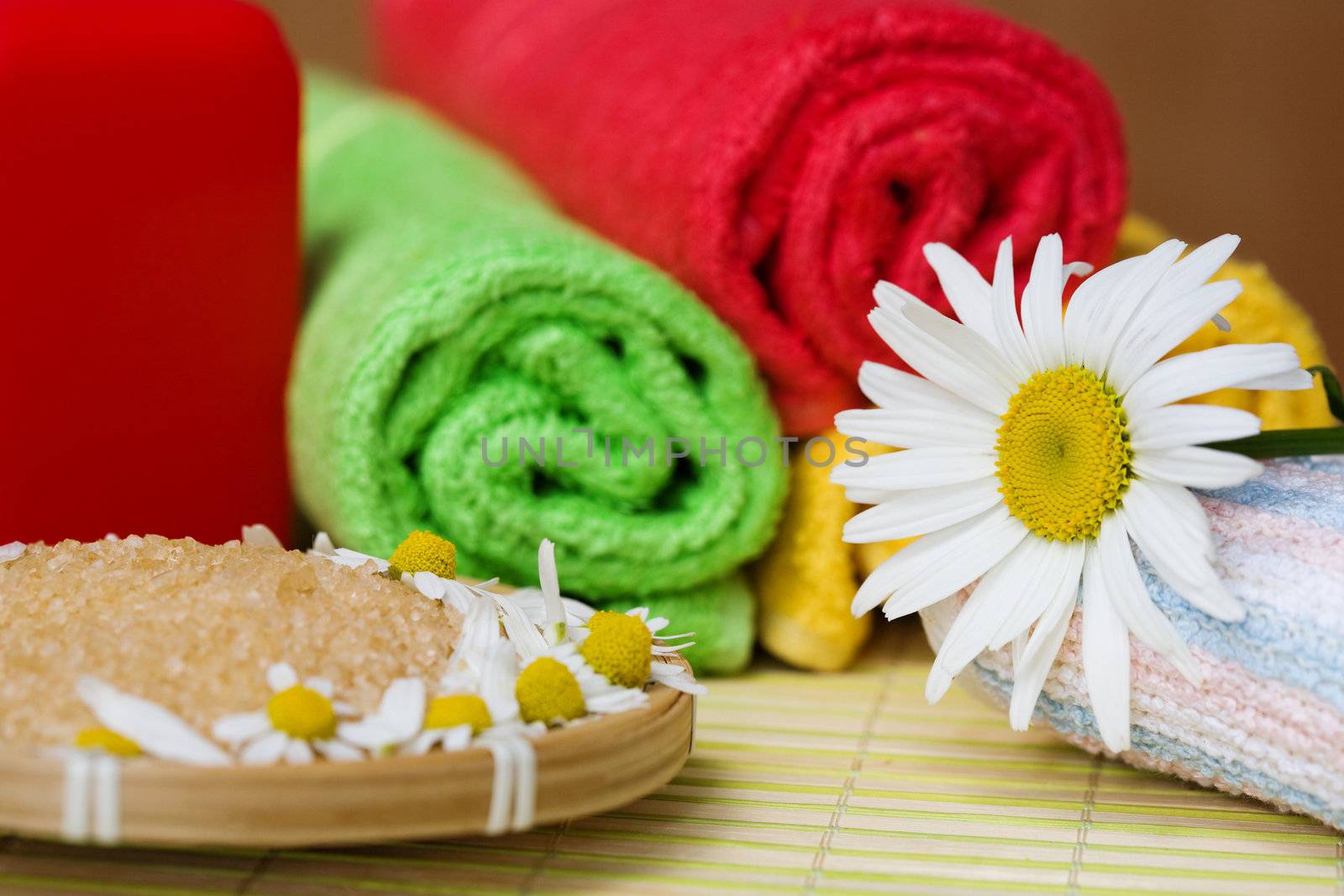 An image of a chamomile, salt and towels