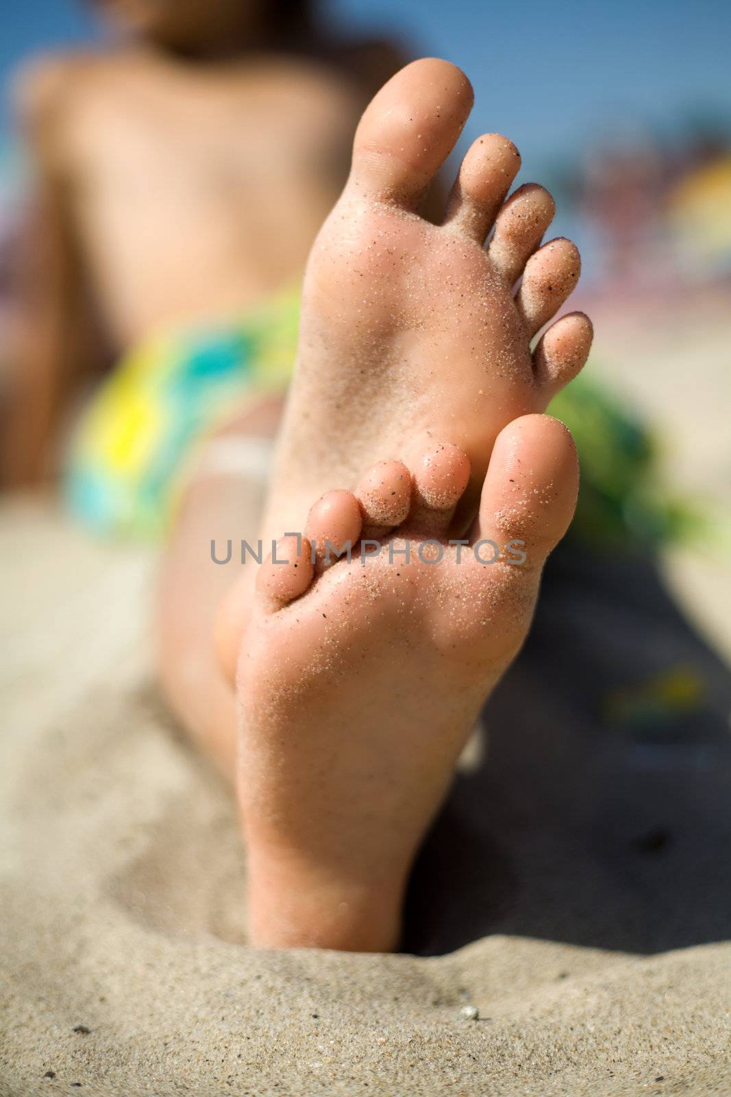 An image of nice feet on the sand