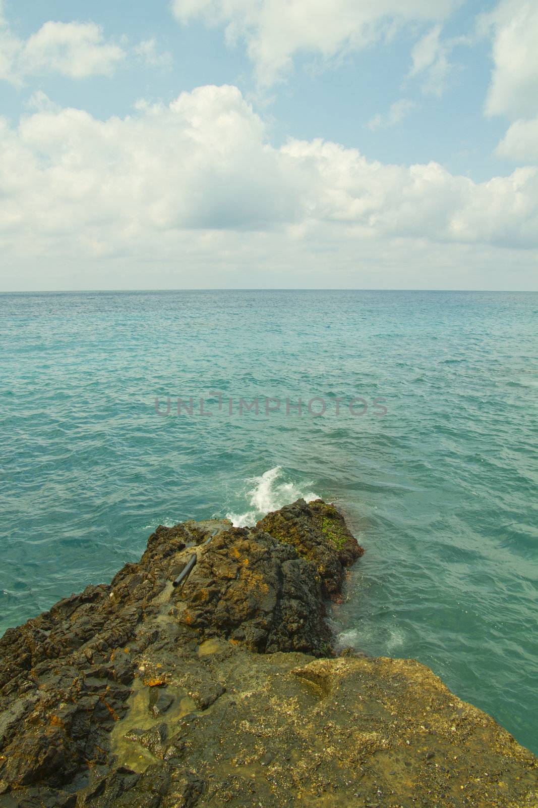 Walk over sea breaking on the rocks