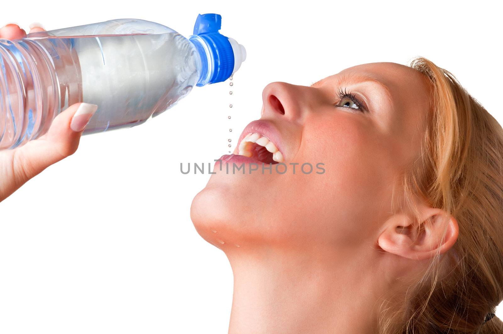 Woman drinking water from a plastic bottle, drops of water falling to her mouth, isolated in white