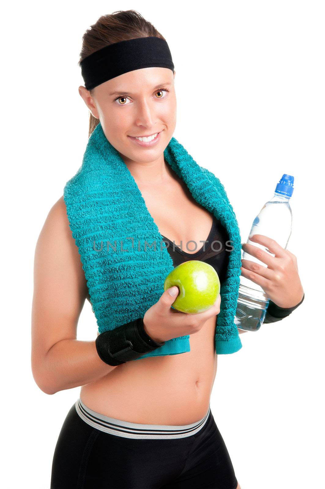 Woman holding an apple and a bottle of water after a workout in the gym, isolated in a white background