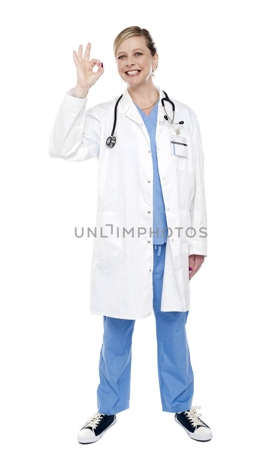 Female medical specialist gesturing ok sign isolated over white background. Full length shot