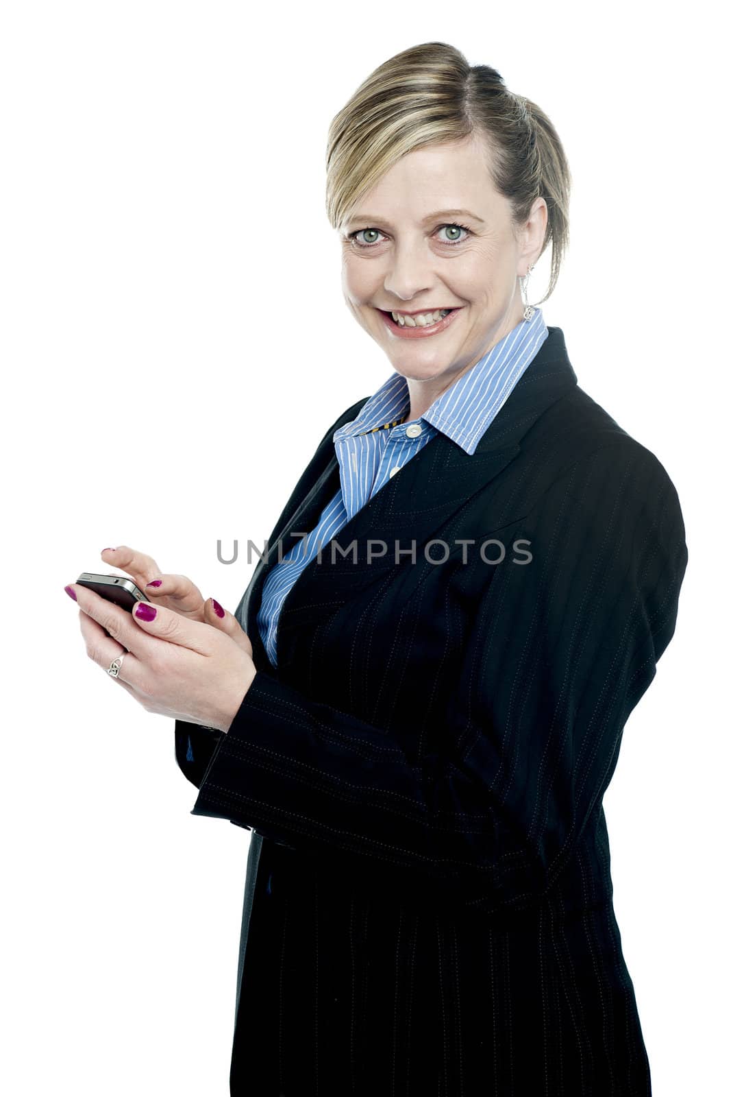 Smiling aged corporate lady using cellphone looking at camera