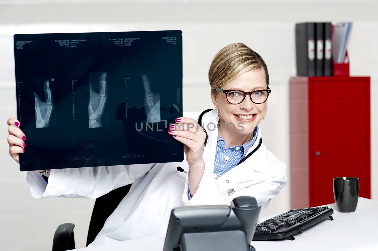 Medical surgeon expert holding x-ray report and showing it to camera