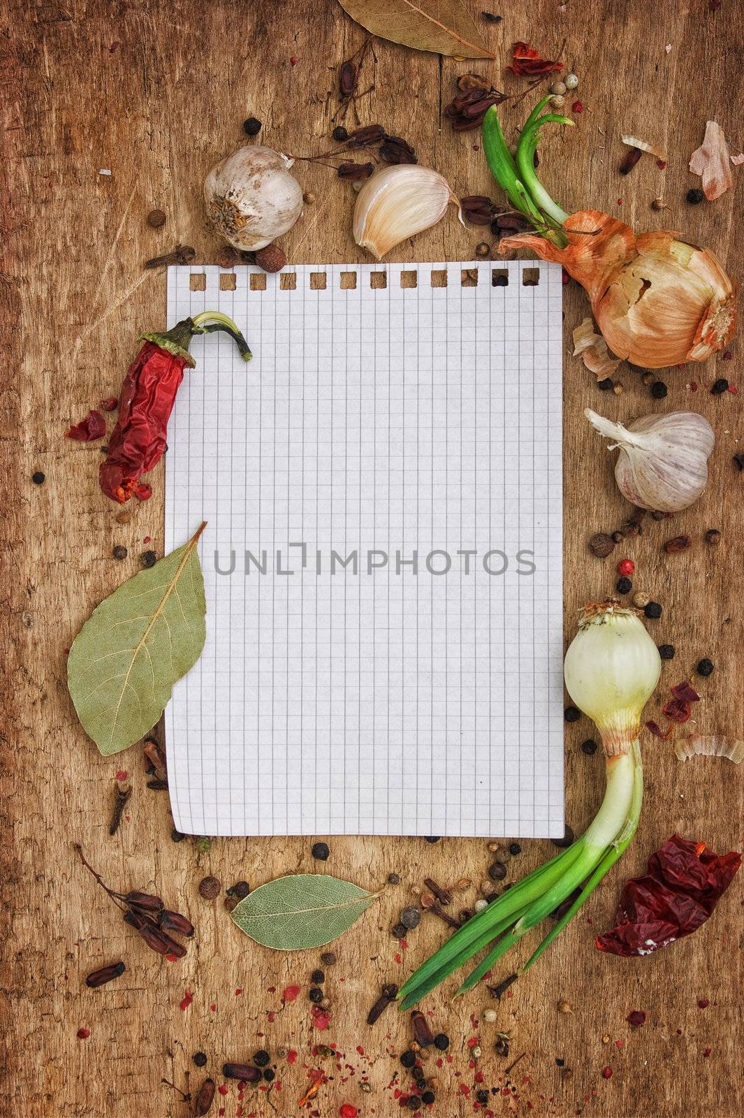 notebook to write recipes on the background of a cutting board with spices