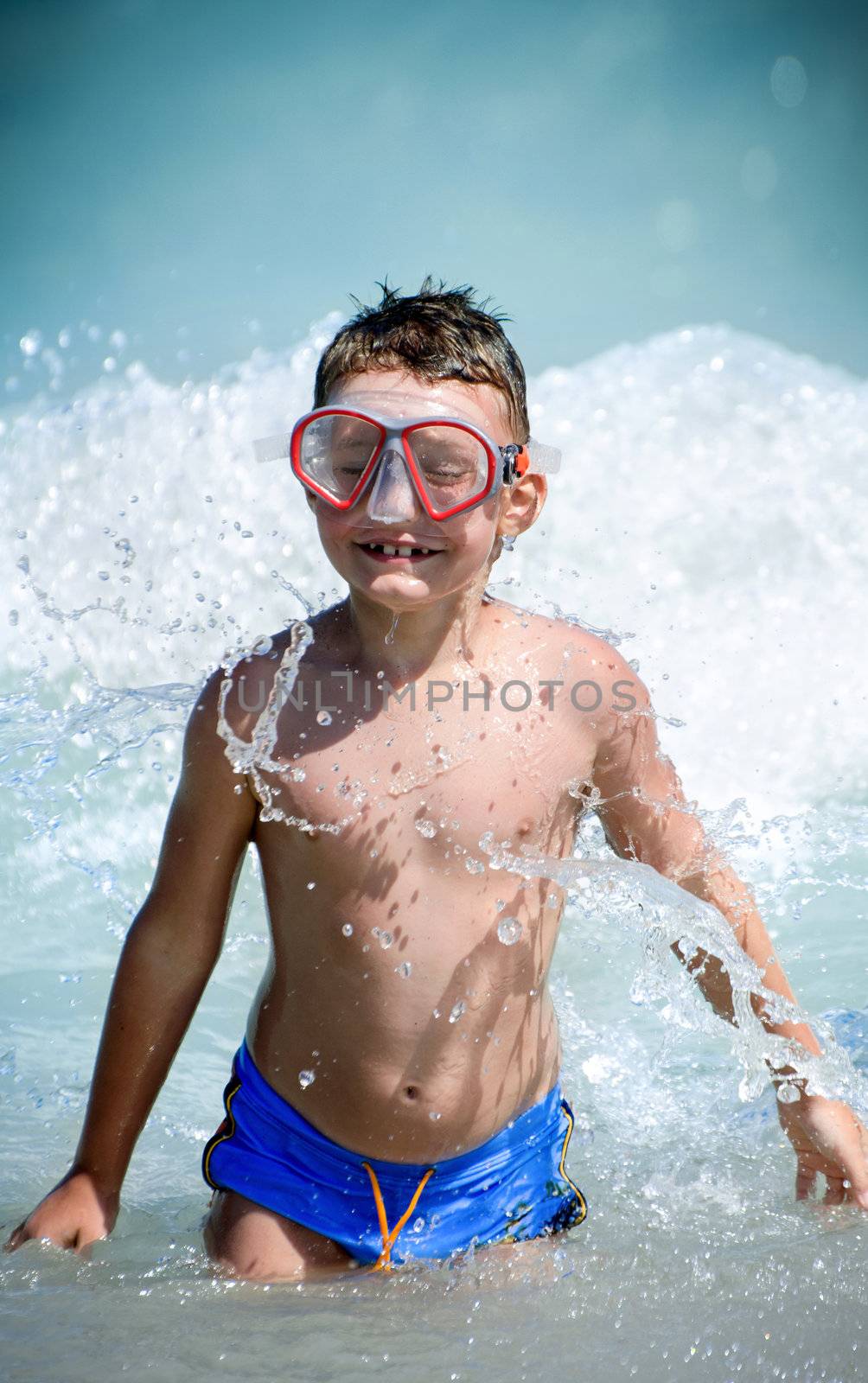 Happy child playing in the black sea