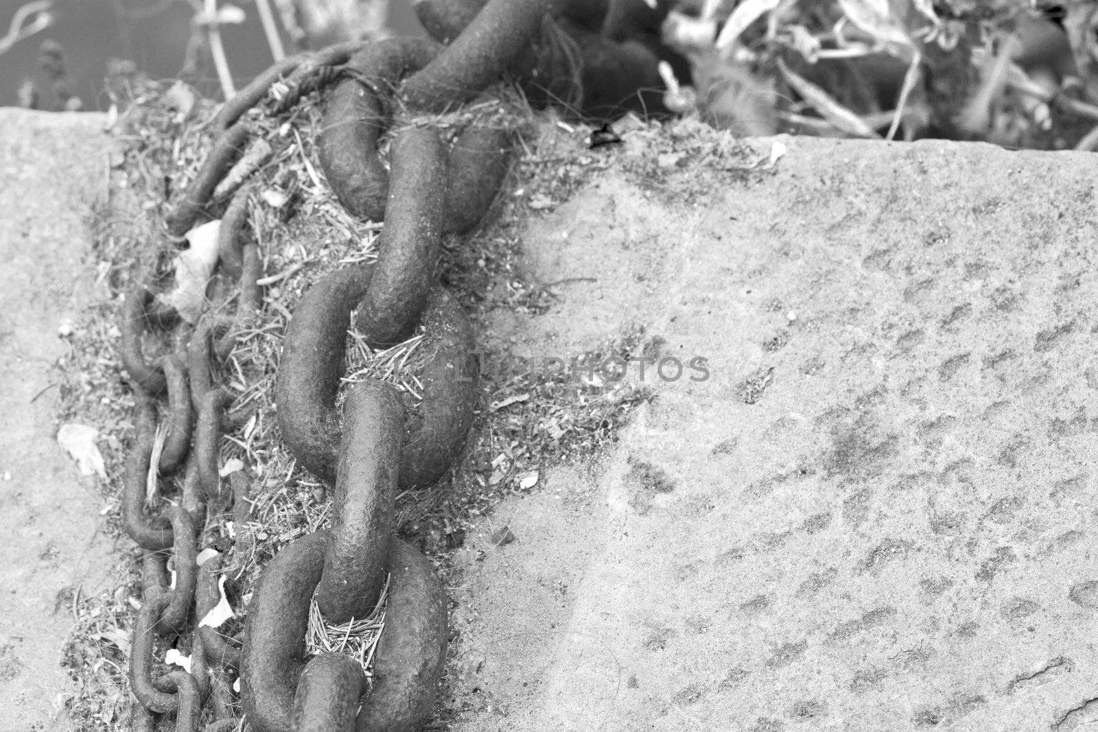 Big boat chain on the dock of and harbour, black and white