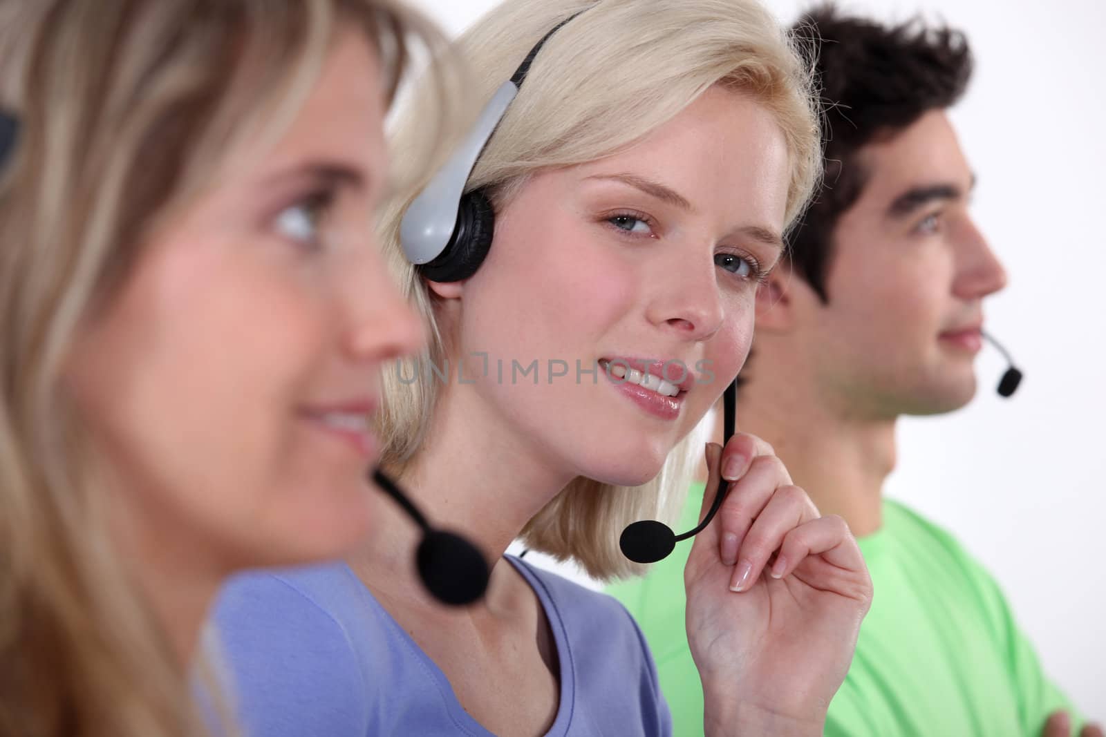 Employees in call center by phovoir