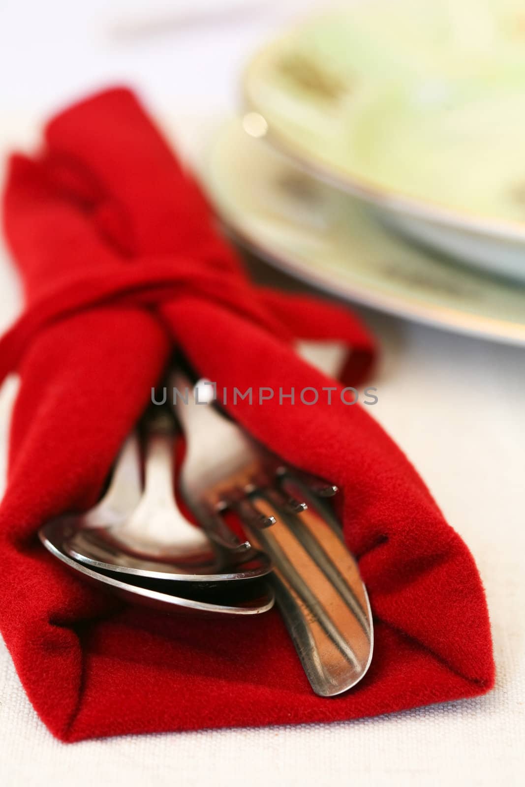 fork, knife and spoon on neutral background