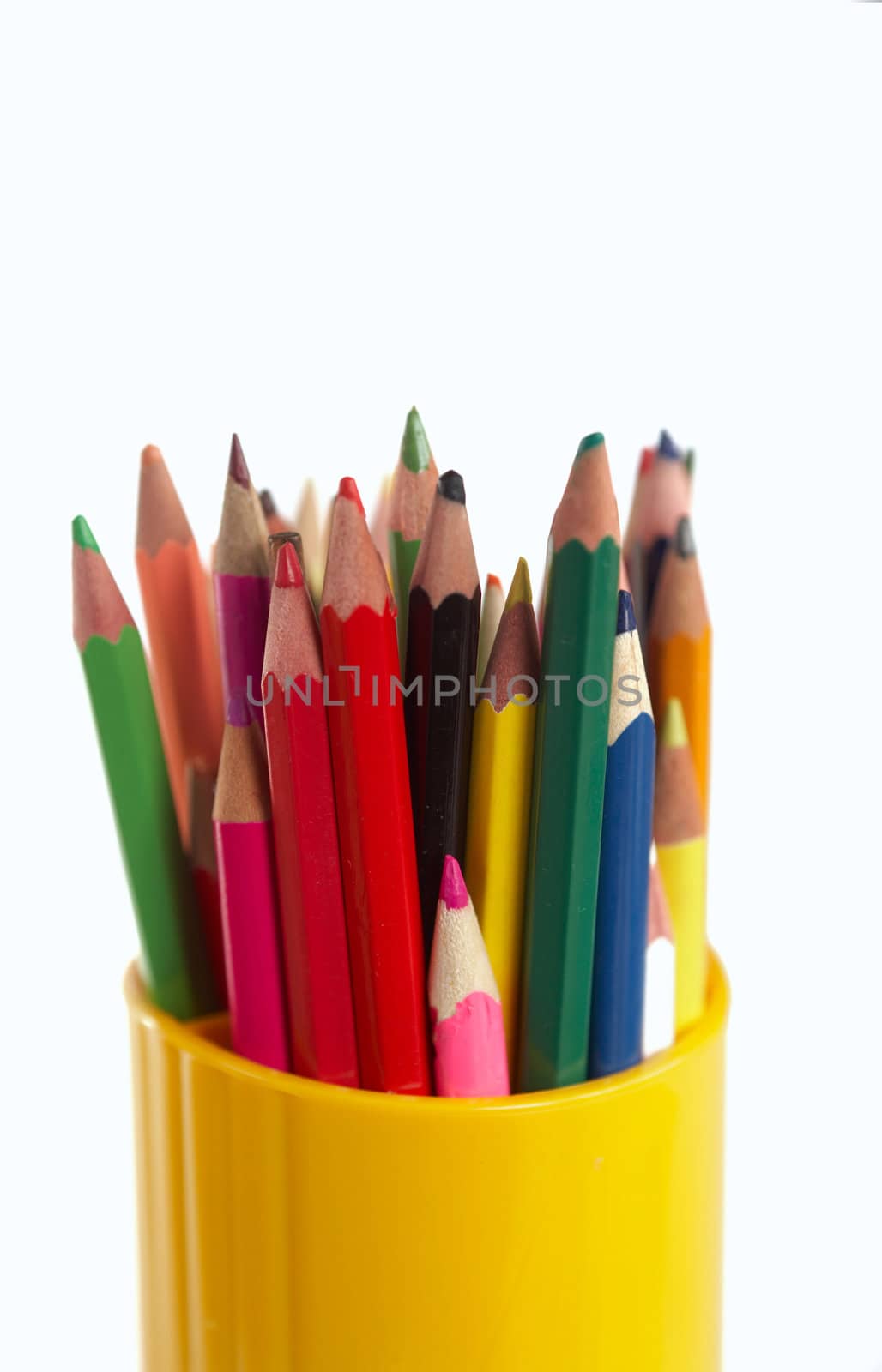 An image of  pencils in a plastic glass