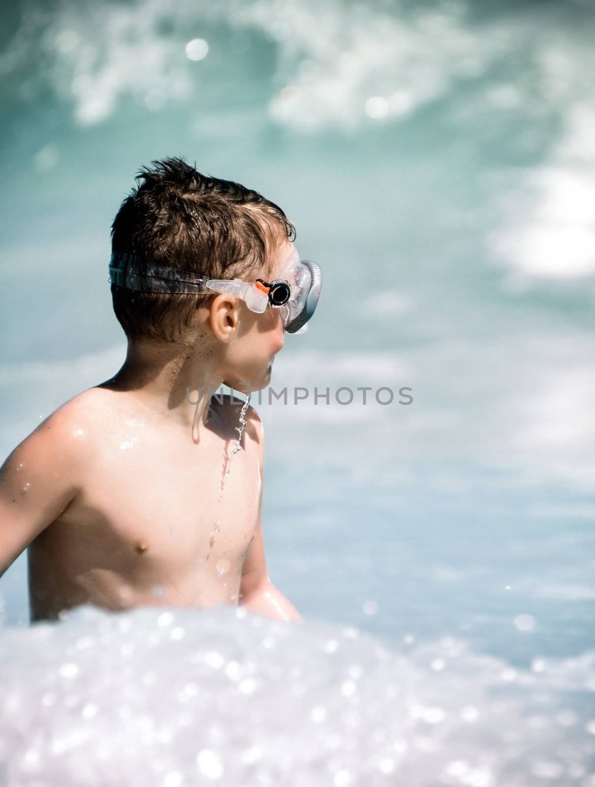 Child expects a wave in sea water