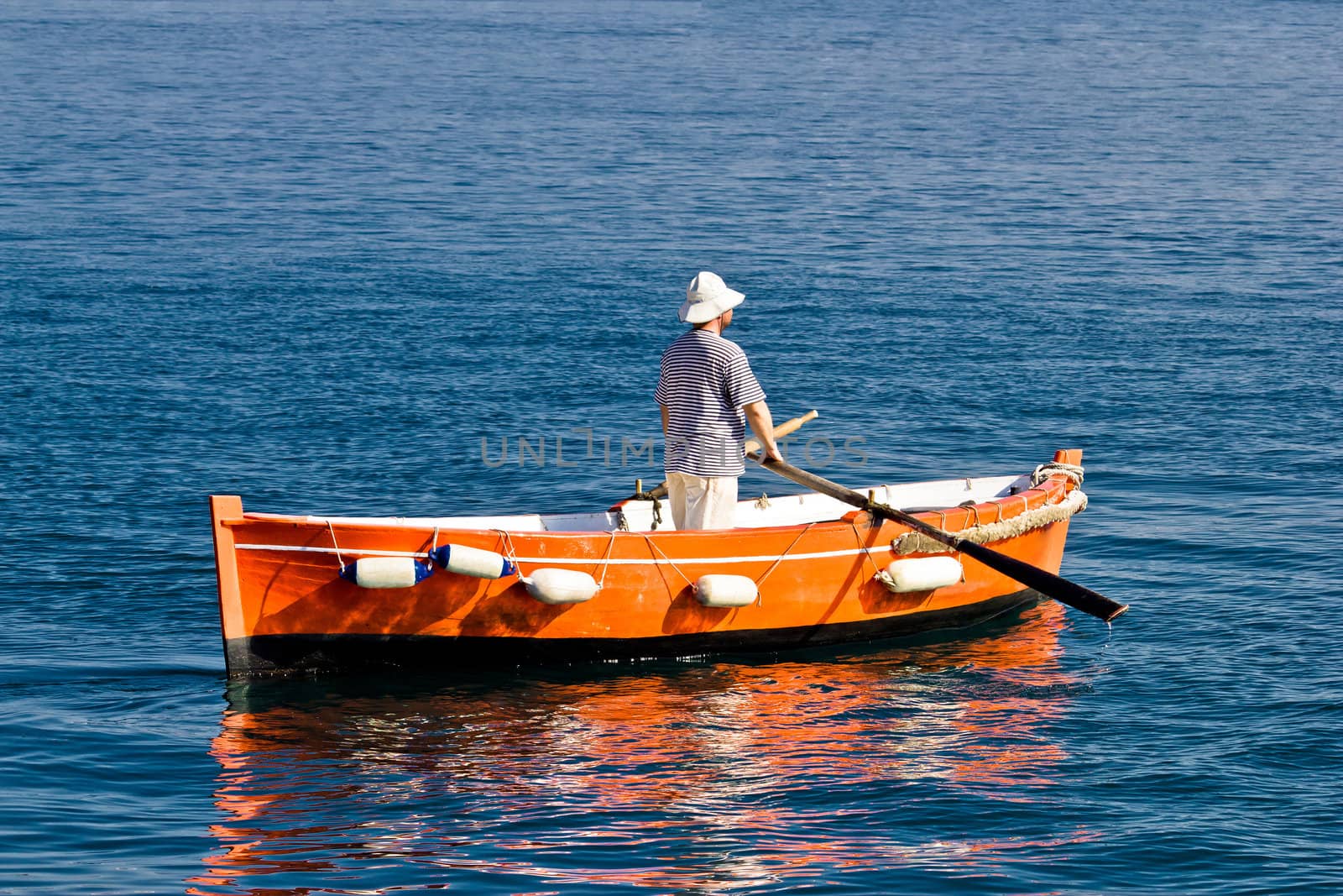 Sailor rowing on wooden taxi boat in Zadar, Croatia