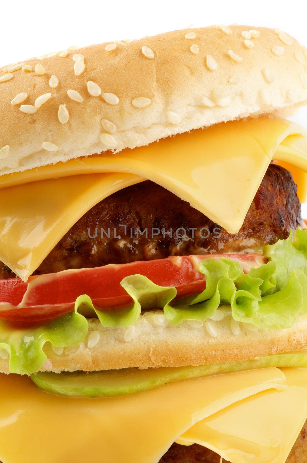 Tasty Cheeseburger with beef, tomato, lettuce and cheese closeup 