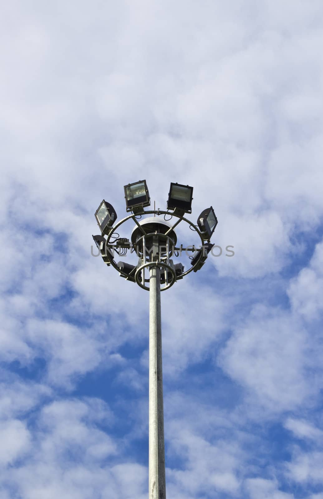 Spot-light tower in blue sky with cloud