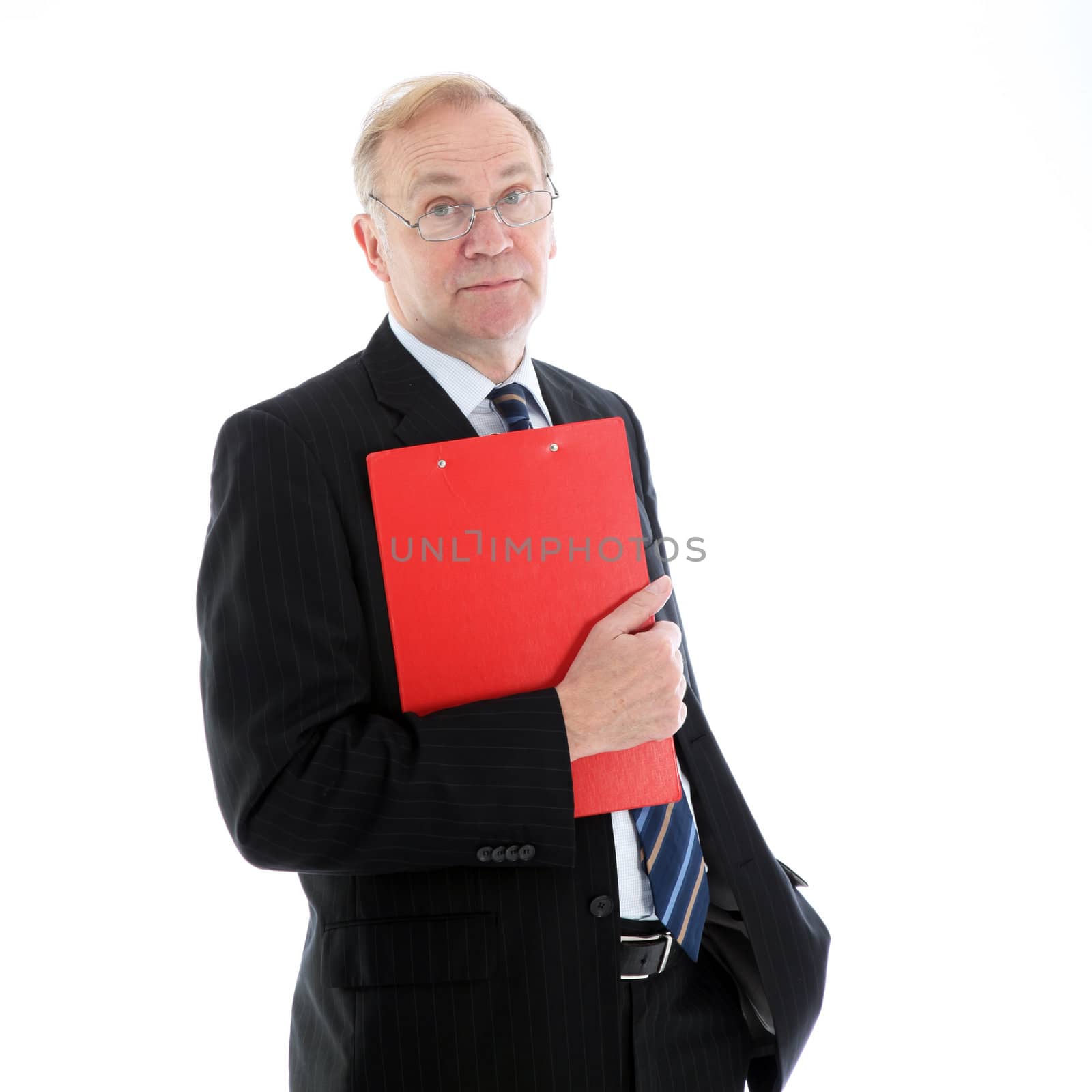 Stylish fashionable middle-aged business executive standing waiting with a red folder under his arm isolated on white 