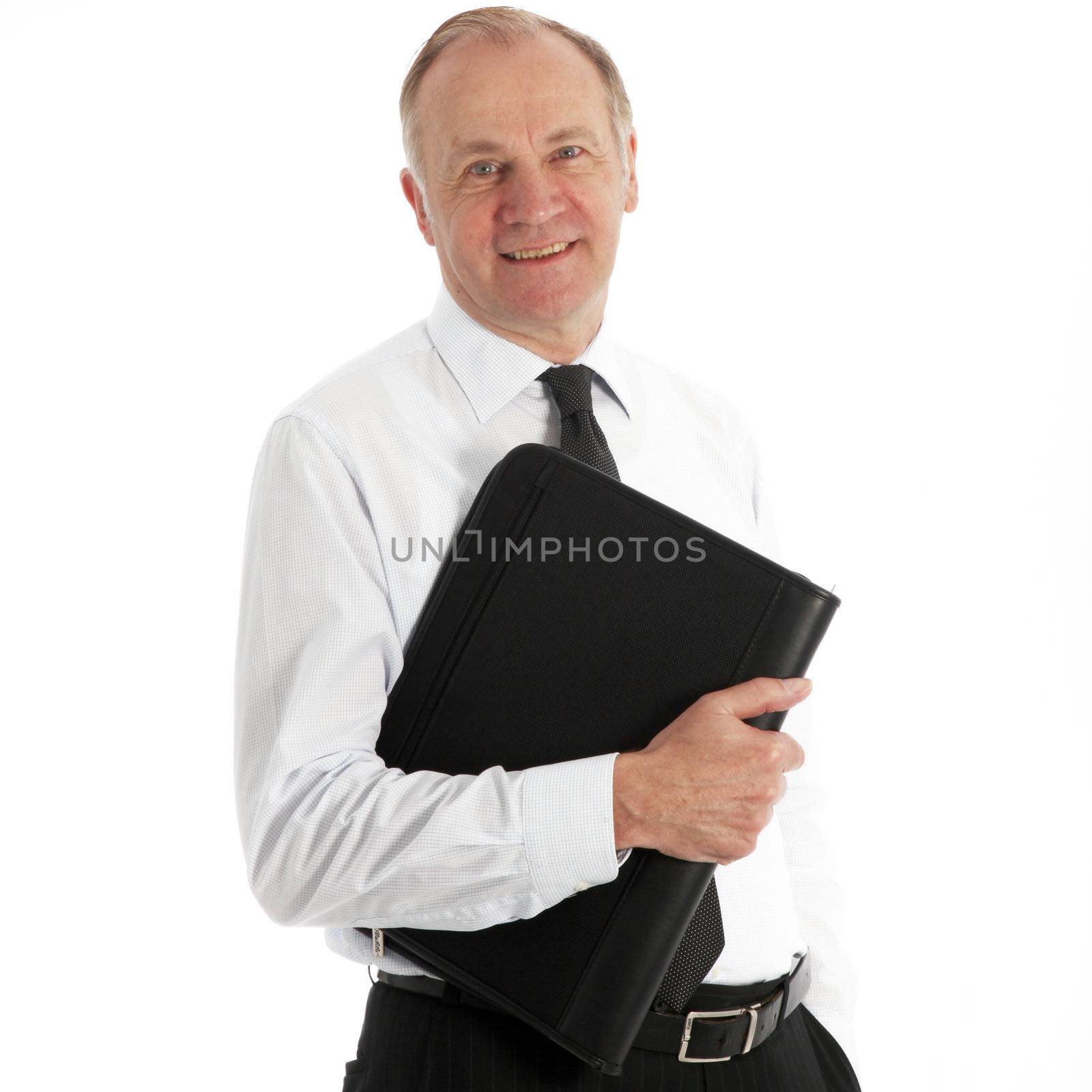 Friendly middle-aged business executive in his shirtsleeves smiling at the camera with a leather portfolio under his arm Friendly middle-aged business executive in his hirtsleeves smiling at the camera with a leather portfolio under his arm 