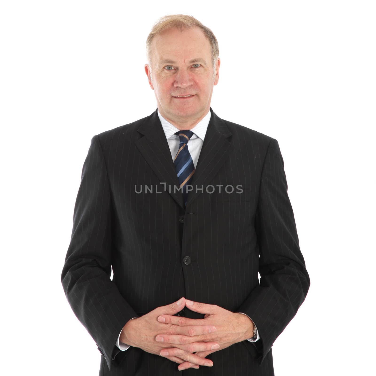 Friendly middle-aged businessman in suit and tie with his hands folded across his stomach isolated on white 