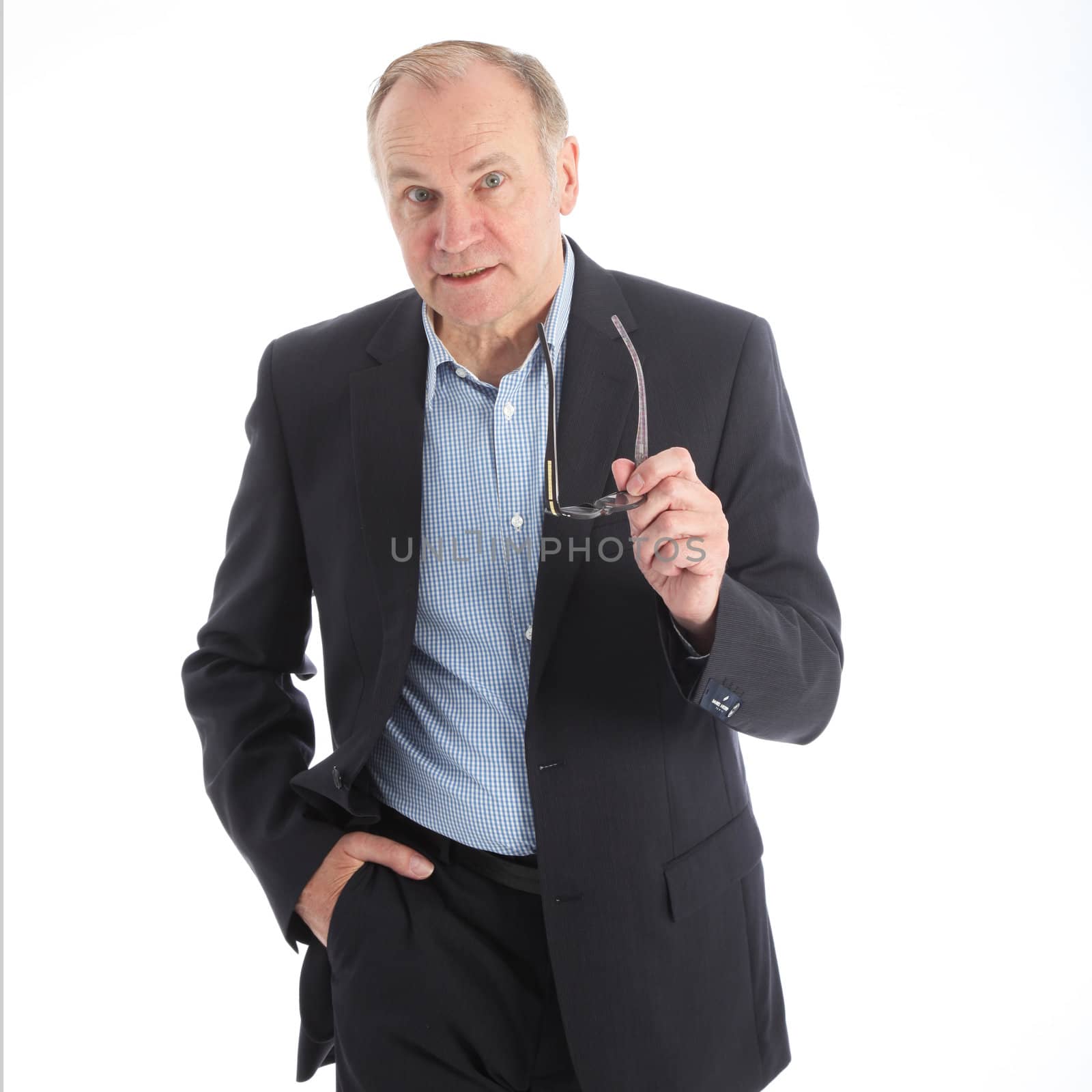 Assertive talkative businessman gesturing with his glasses as he tries to make a point in the discussion 