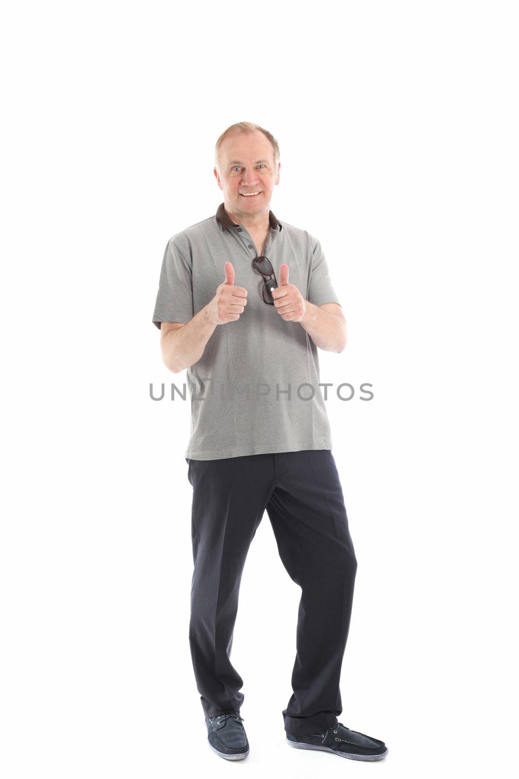 Full length studio portrait of a fashionable smiling middle-aged man giving a thumbs up gesture of approval and success Full lrngth studio portrait of a fashionable smiling middle-aged man giving a thumbs up gesture of approval and success