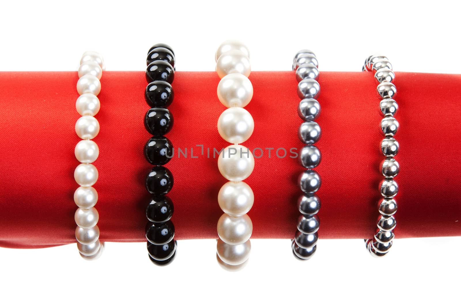 Women's bracelets on the red hat on a white background